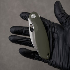 Closed G064 in hand – green handle, satin edge