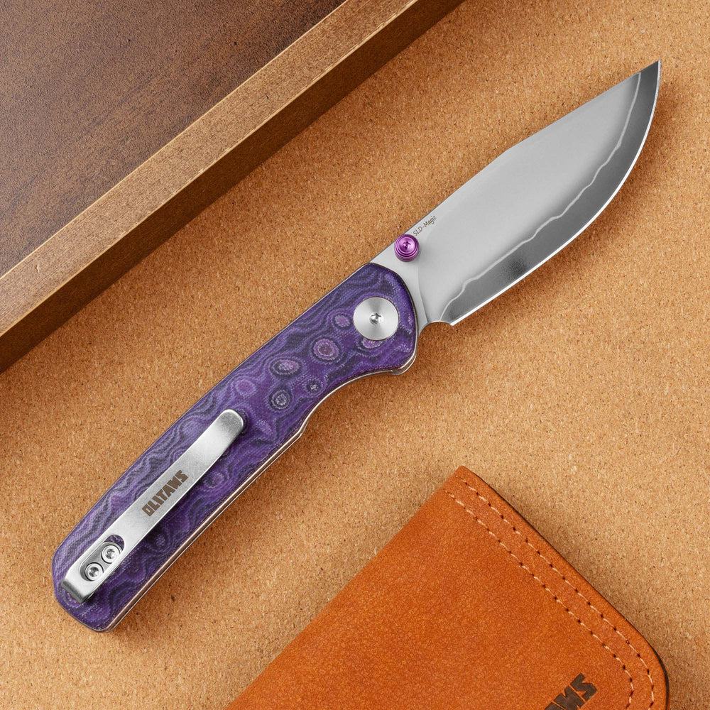 Open OLITANS Gecko SE G080 Purple Micarta knife showing clip side and gradient blade