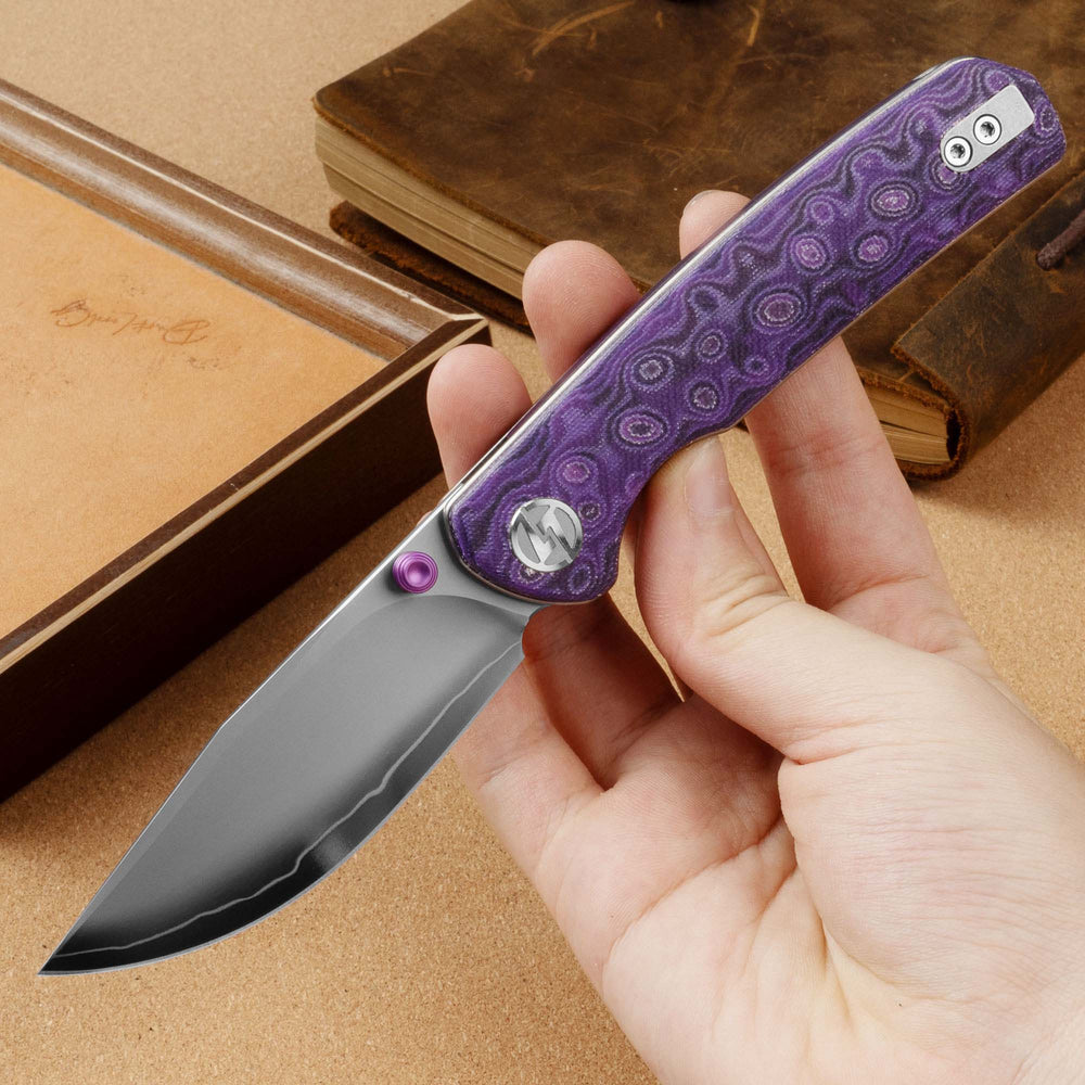 Open OLITANS Gecko SE G080 Purple Micarta liner lock knife held in hand