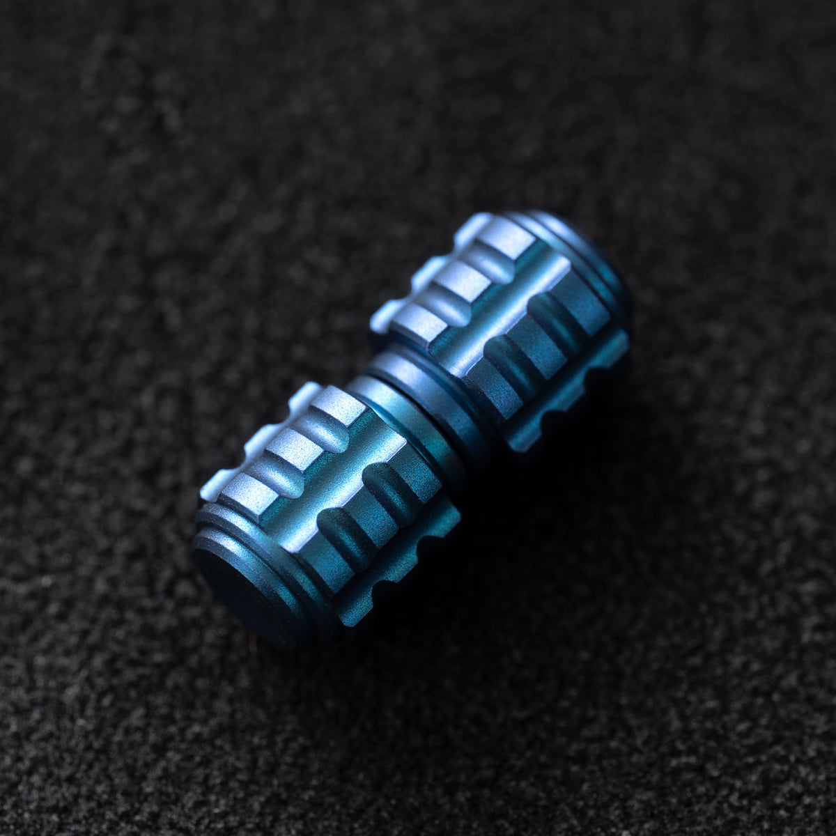 Blue OLITANS grenade-style TC4 titanium thumb stud