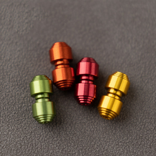 OLITANS anodized aluminum thumb studs in green, orange, red, and gold